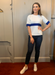 white short sleeve knit top with blue stripe across chest and sleeves